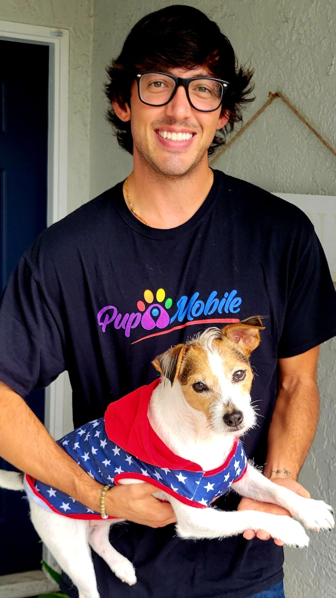 A Pup Mobile team member holding Rosie