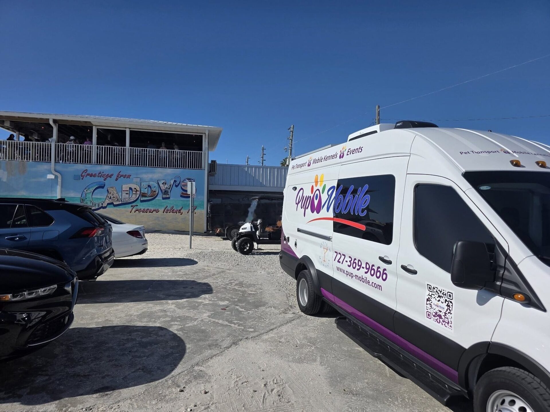 The Pup Mobile van at a curb, ready for pickup