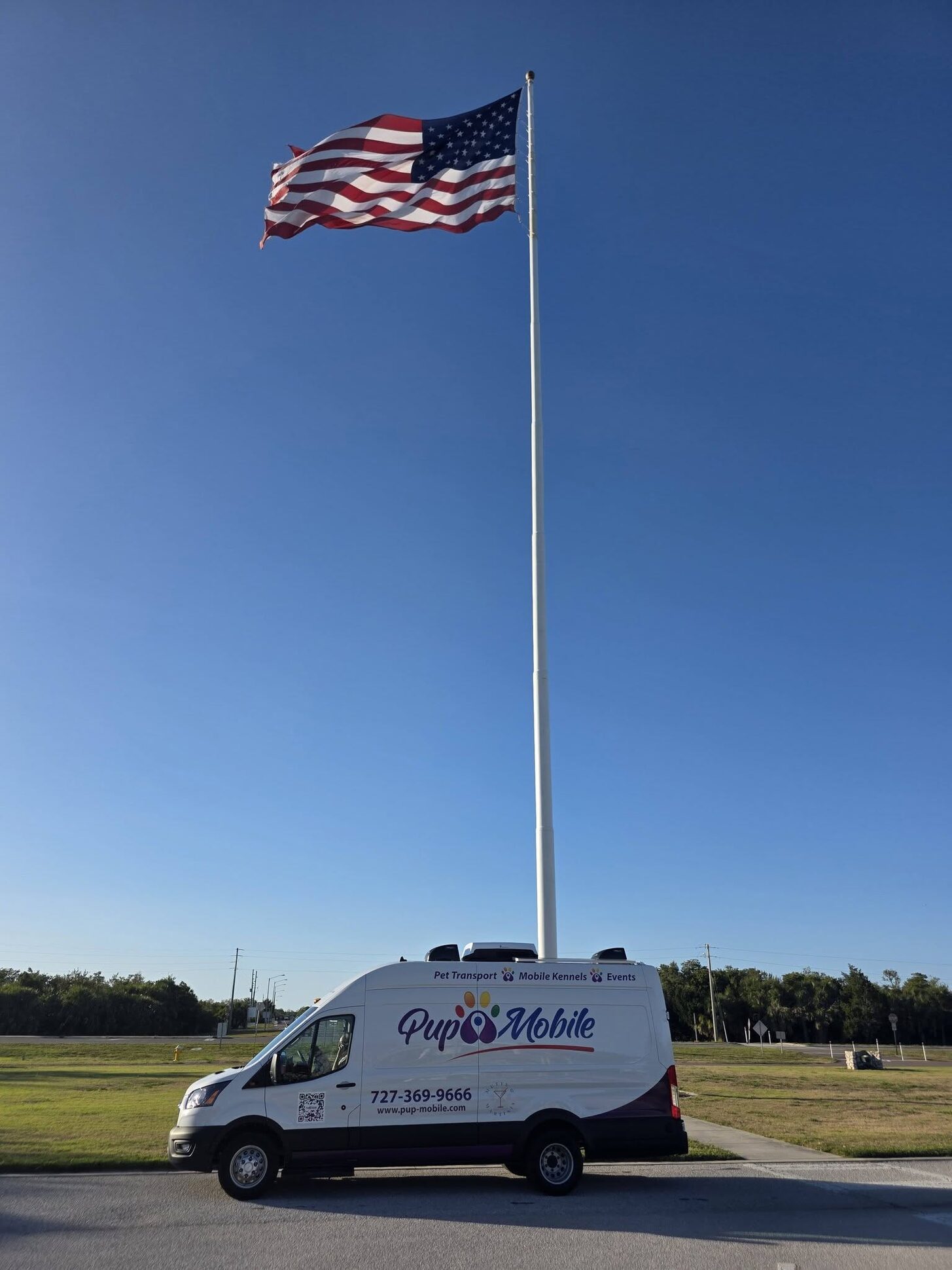 The Pup Mobile van beneath a giant American flag
